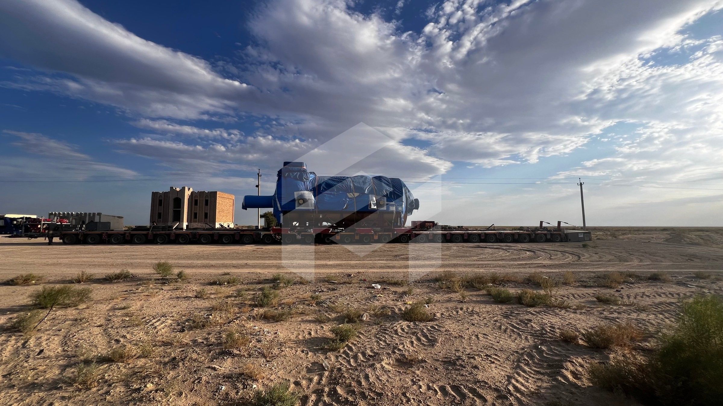 The gas turbine generator on modular trailers in open country under clouds