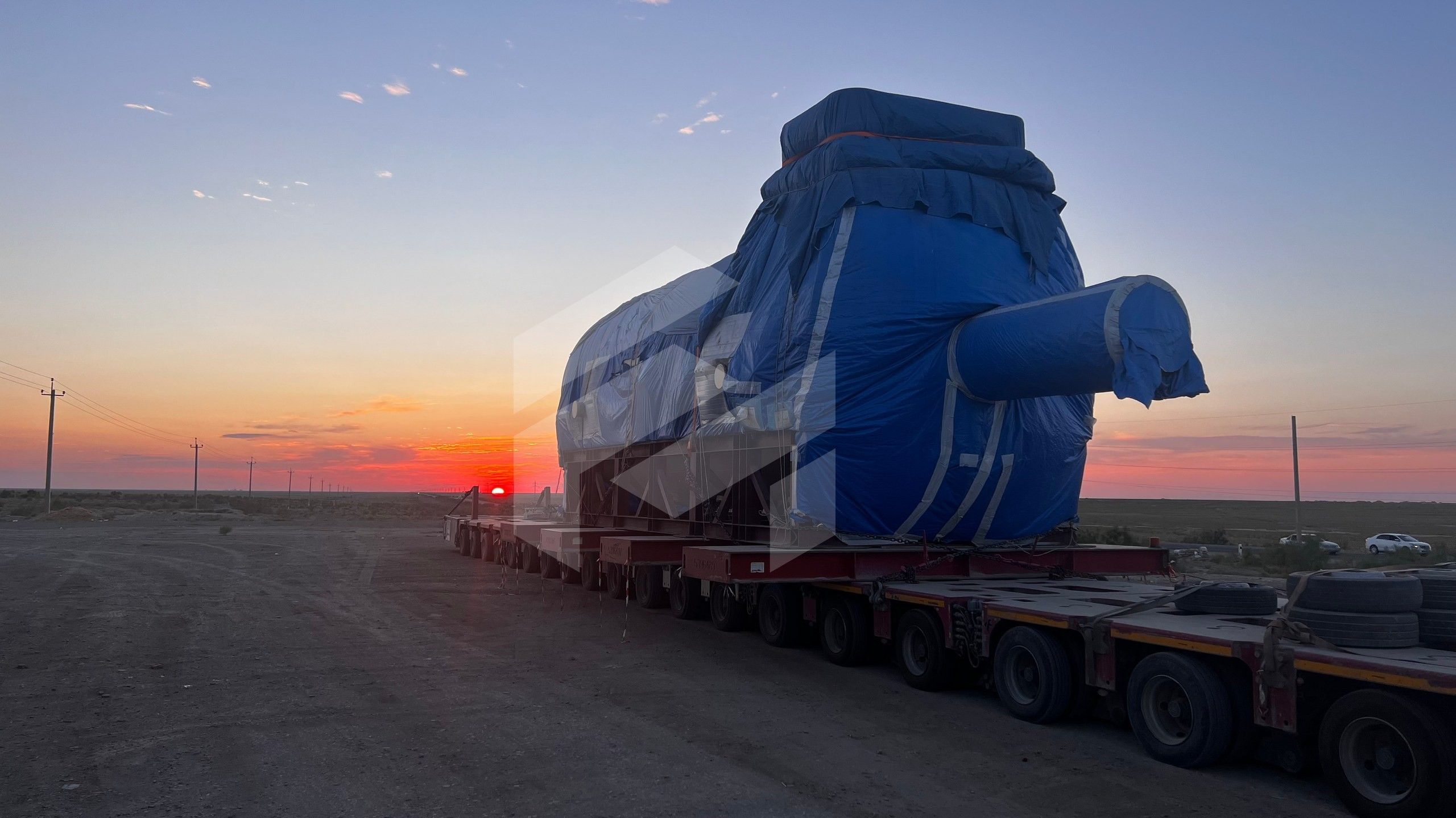 The 309 t gas turbine generator on modular trailers at sunset