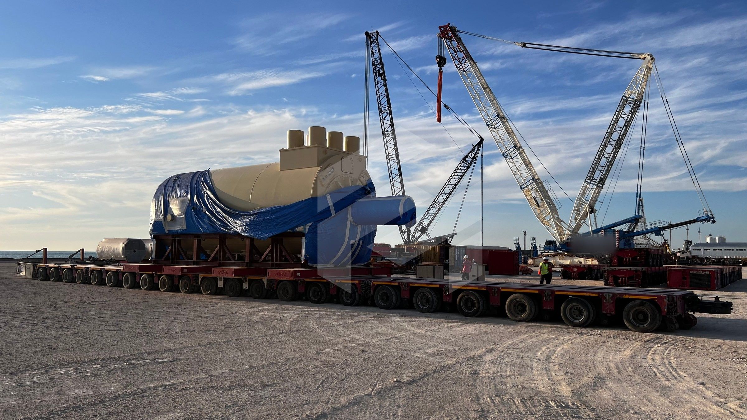 Two cranes beside the gas turbine generator on modular trailers